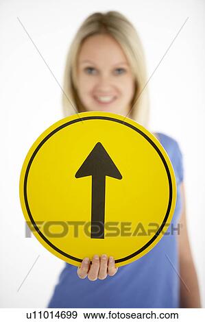 Stock Photo - Woman Holding Road Traffic Sign. Fotosearch