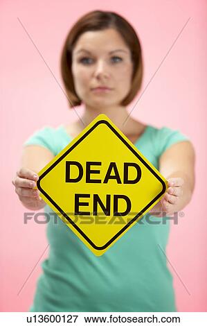 Stock Photo - Woman Holding Road Traffic Sign. Fotosearch