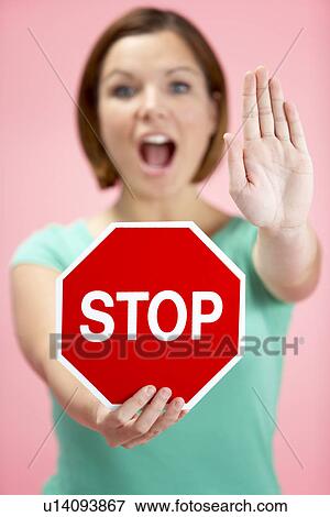 Stock Photo - Woman Holding Road Traffic Sign. Fotosearch
