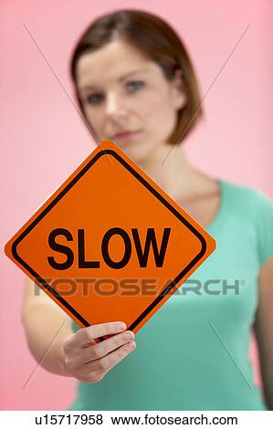 Stock Photo - Woman Holding Road Traffic Sign. Fotosearch