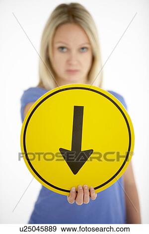 Stock Photo - Woman Holding Road Traffic Sign. Fotosearch