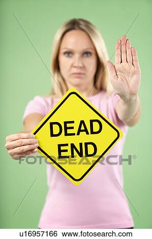 Stock Photograph - Woman Holding Road Traffic Sign. Fotosearch