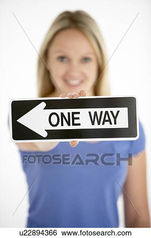 Stock Photograph - Woman Holding Road Traffic Sign. Fotosearch