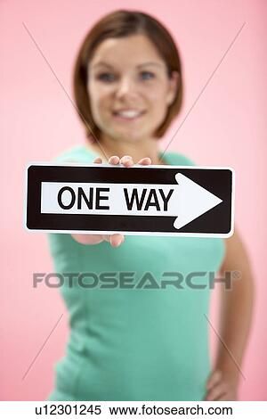 Stock Photography - Woman Holding Road Traffic Sign. Fotosearch