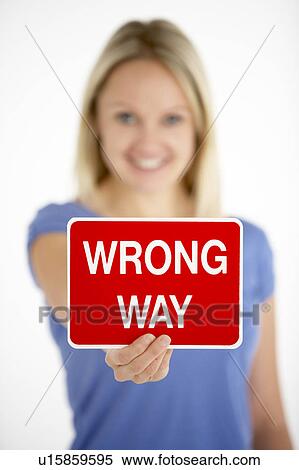 Stock Photography - Woman Holding Road Traffic Sign. Fotosearch