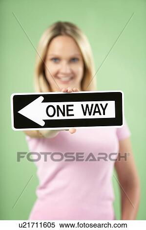 Stock Photography - Woman Holding Road Traffic Sign. Fotosearch