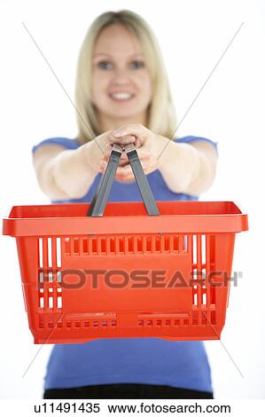 Stock Photography - Woman Holding Shopping Basket. Fotosearch