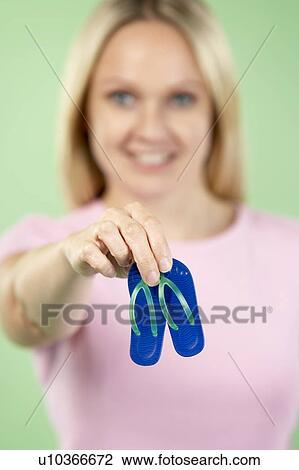 Woman Holding Small Beach Sandals View Large Photo Image Stock Image - Woman Holding Small Beach Sandals. Fotosearch