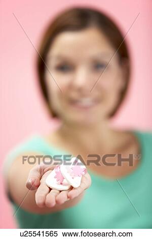 Stock Photography - Woman Holding Small Beach Sandals. Fotosearch