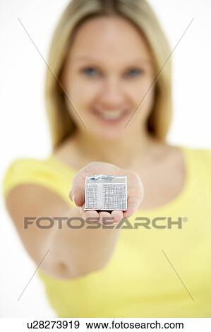 Stock Photo - Woman Holding Small Gift. Fotosearch