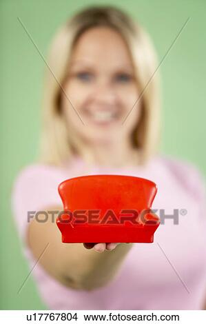Picture - Woman Holding Small Sofa. Fotosearch