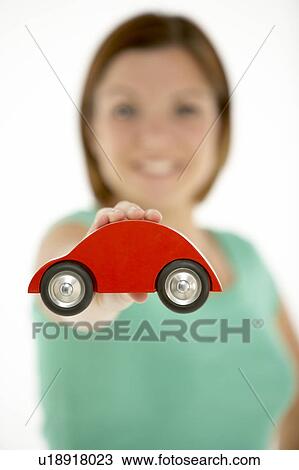 Stock Image - Woman Holding Toy Car. Fotosearch