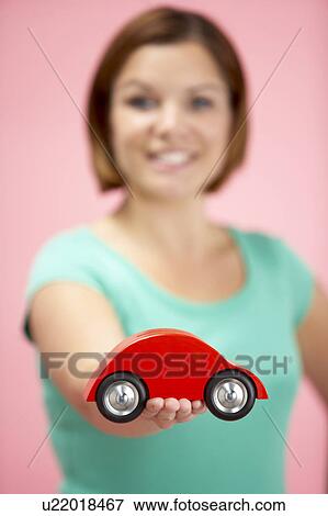 Stock Photo - Woman Holding Toy Car. Fotosearch