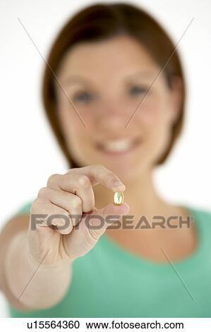 Woman Holding Vitamin Capsule View Large Photo Image Stock Image - Woman Holding Vitamin Capsule. Fotosearch