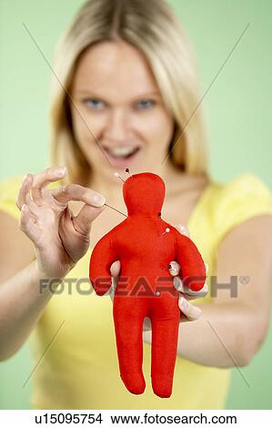 Picture - Woman Holding Voodoo Doll. Fotosearch