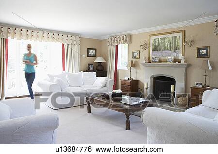 Stock Photograph - Woman Walking Through Lounge. Fotosearch