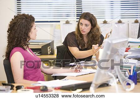 Stock Photo - Women having an argument at work. Fotosearch