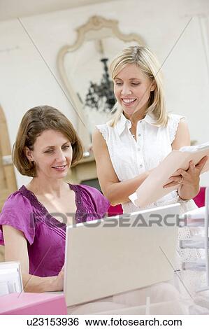 Women looking at laptop together View Large Photo Image Stock Photograph - Women looking at laptop together. Fotosearch