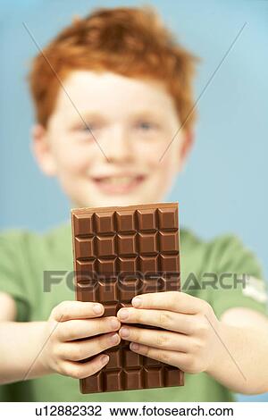 Young Boy Holding Bar Of Chocolate View Large Photo Image Stock Image - Young Boy Holding Bar Of Chocolate. Fotosearch