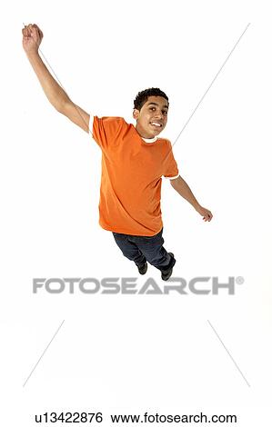 Stock Photograph - Young Boy Leaping In Studio. Fotosearch
