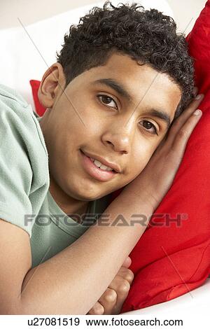 Young Boy Relaxing On Sofa View Large Photo Image Stock Photo - Young Boy Relaxing On Sofa. Fotosearch