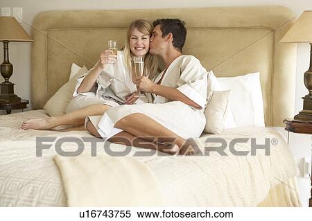 Young Couple Enjoying Champagne In Bedroom View Large Photo Image Stock Photography - Young Couple Enjoying Champagne In Bedroom. Fotosearch