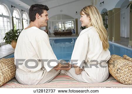 Young Couple Relaxing By Swimming Pool View Large Photo Image Stock Photo - Young Couple Relaxing By Swimming Pool. Fotosearch