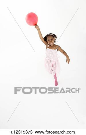 Stock Image - Young Girl Holding Party Balloon. Fotosearch