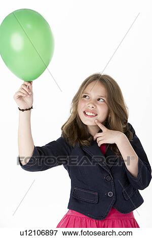 Stock Photo - Young Girl Holding Party Balloon. Fotosearch