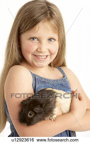 Stock Photograph - Young Girl Holding Pet Guinea Pig. Fotosearch