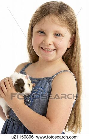 Stock Photograph - Young Girl Holding Pet Guinea Pig. Fotosearch