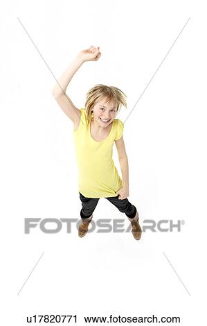 Stock Image - Young Girl Leaping In Studio. Fotosearch