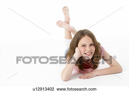 Young Girl Lying On Stomach In Studio View Large Photo Image Stock Image - Young Girl Lying On Stomach In Studio. Fotosearch