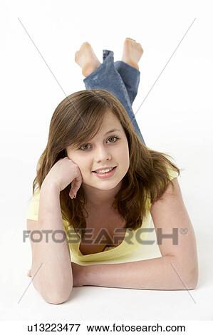 Young Girl Lying On Stomach In Studio View Large Photo Image Stock Photo - Young Girl Lying On Stomach In Studio. Fotosearch