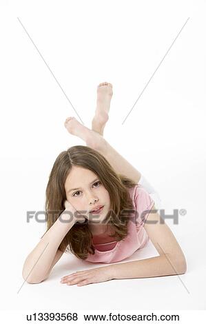 Young Girl Lying On Stomach In Studio View Large Photo Image Stock Photo - Young Girl Lying On Stomach In Studio. Fotosearch