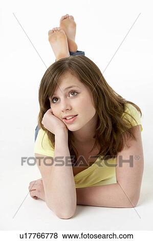 Young Girl Lying On Stomach In Studio View Large Photo Image Stock Photo - Young Girl Lying On Stomach In Studio. Fotosearch