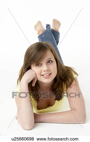 Stock Photo - Young Girl Lying On Stomach In Studio. Fotosearch