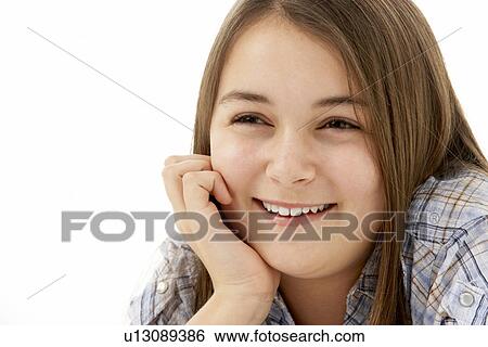 Stock Photograph - Young Girl Lying On Stomach In Studio. Fotosearch
