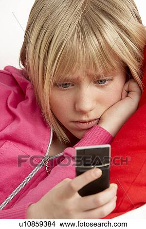 Young Girl Reading Text And Looking Worried View Large Photo Image Picture - Young Girl Reading Text And Looking Worried. Fotosearch