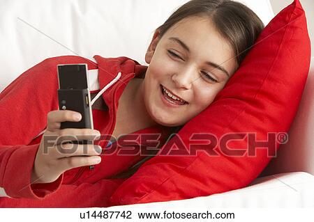 Stock Image - Young Girl Reading Text Message. Fotosearch