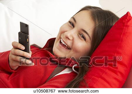 Stock Photo - Young Girl Reading Text Message. Fotosearch