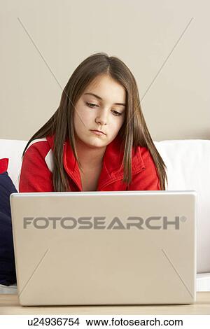 Picture - Young Girl Using Laptop At Home. Fotosearch