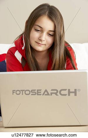 Young Girl Using Laptop At Home View Large Photo Image Stock Photo - Young Girl Using Laptop At Home. Fotosearch