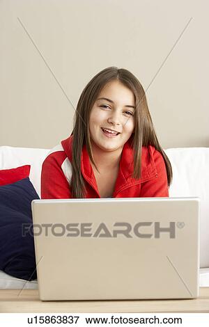 Young Girl Using Laptop At Home View Large Photo Image Stock Photo - Young Girl Using Laptop At Home. Fotosearch