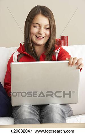 Stock Photo - Young Girl Using Laptop At Home. Fotosearch