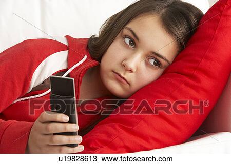 Stock Image - Young Girl Waiting For Phone Call. Fotosearch