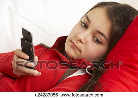 Stock Photograph - Young Girl Waiting For Phone Call. Fotosearch