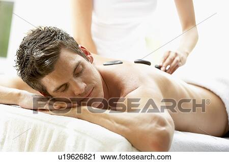 Young Man Enjoying Hot Stone Treatment View Large Photo Image Stock Image - Young Man Enjoying Hot Stone Treatment. Fotosearch