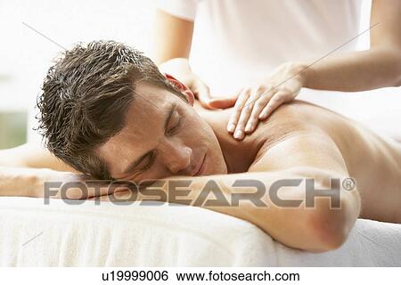 Stock Photograph - Young Man Enjoying Massage At Spa. Fotosearch