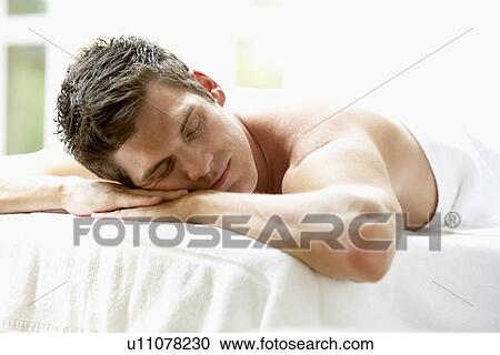 Stock Image - Young Man Relaxing On Massage Table. Fotosearch